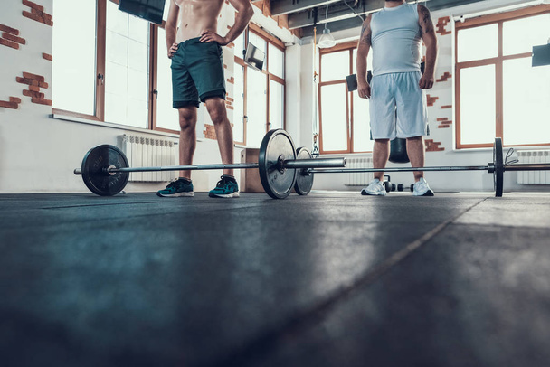 Two Powerful Guys In Gym Are Lifting Barbells. Training Day. Fitness Club. Healthy Lifestyle. Athlete Stamina. Active Holidays. Crossfit Concept. Body Shape. Comfortable Sportswear. No Face. - Foto, immagini