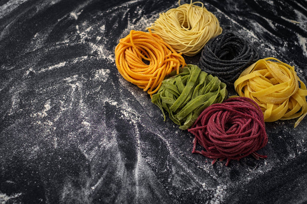 fresh coloured pasta on black top view - Foto, Imagem