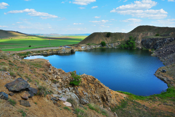 Iacobdeal lake ,formed in a collapsed mine gallery, near Macin mountains, Tulcea county, Romania - Valokuva, kuva
