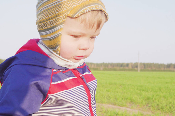 one year old boy farmer standing in the field with young wheat - Zdjęcie, obraz
