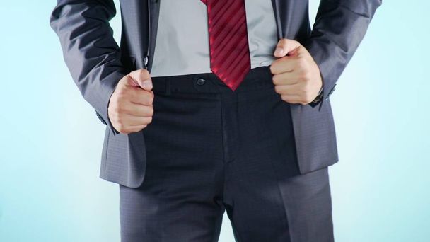 Colorful background. Close-up. Thighs of a man. businessmen cheerfully moves his hips - Foto, Imagem