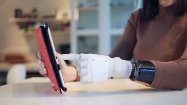 Woman is operating a tablet with her prosthetic hand - Felvétel, videó