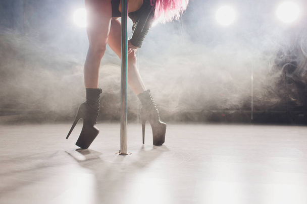 young striptease dancer moving in high heels shoes on stage in strip night club, Pole dancing - Valokuva, kuva