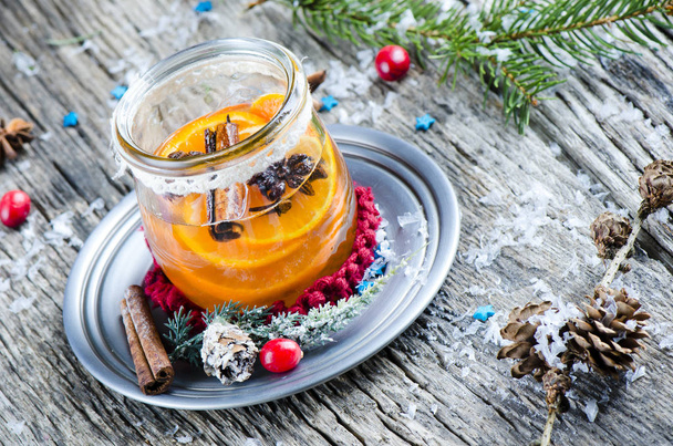Festive tangerine liqueur with Christmas decorations on wooden tabletop - Photo, Image