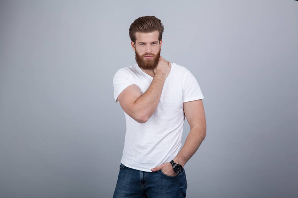 Serious thoughtful male with ginger beard, dressed casually, focused somewhere, isolated over white backgroun - Фото, изображение