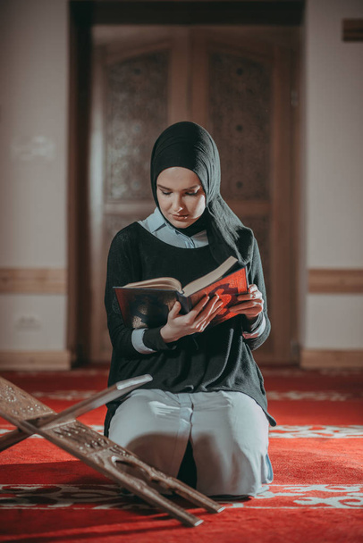 Muslim woman praying and reading Quran - Photo, image