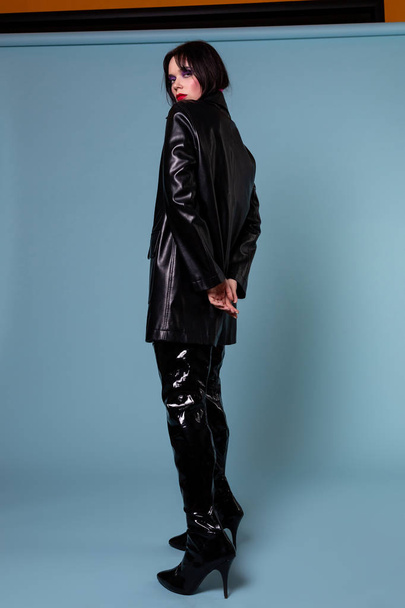 Glamour model with dark short hair in oversize black leather jacket - Photo, Image