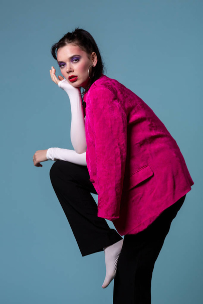 Amazing young brunett woman in trendy pink jacket standing on one leg - Fotoğraf, Görsel
