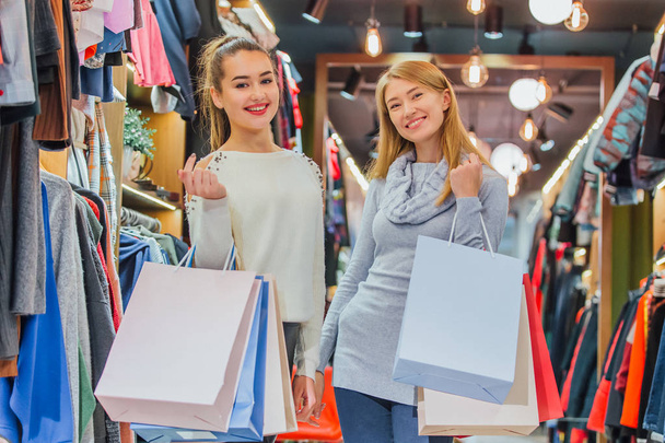 Happy women with shopping bags in the store - Foto, Bild