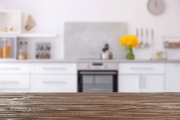 Empty brown wooden table in modern kitchen. Mockup for design - Zdjęcie, obraz