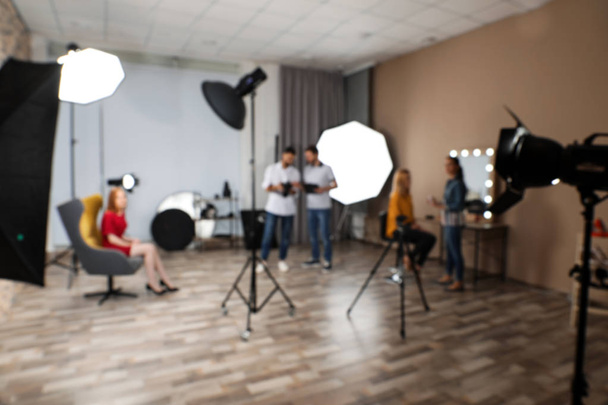 Photo studio with professional equipment and team of workers - Valokuva, kuva