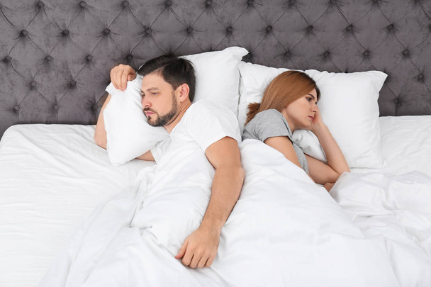 Couple with relationship problems in bed at home - Foto, afbeelding