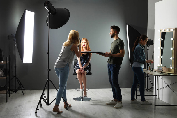 Photo studio with professional equipment and team of workers - Foto, imagen
