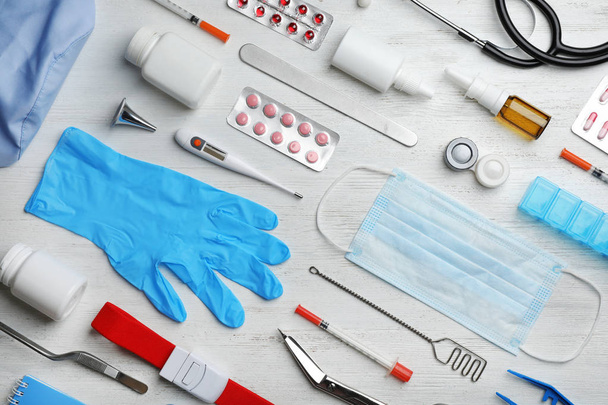 Flat lay composition with medical objects on white wooden background - Photo, Image
