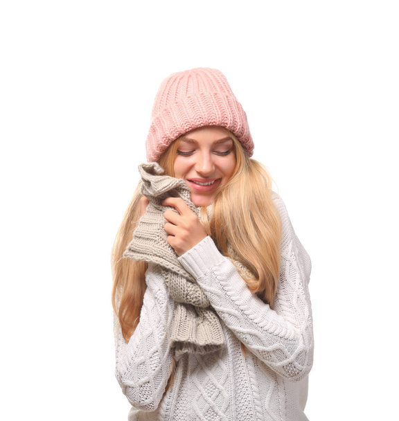 Portrait of emotional young woman in stylish hat and sweater with scarf on white background. Winter atmosphere - Fotografie, Obrázek