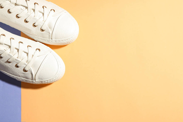 Pair of stylish sneakers on color background, top view with space for text - Foto, Bild
