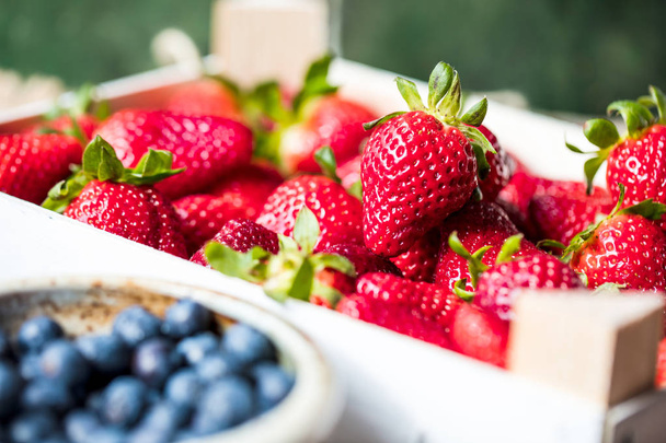 close-up view of fresh ripe strawberries and blueberries, selective focus - Photo, Image