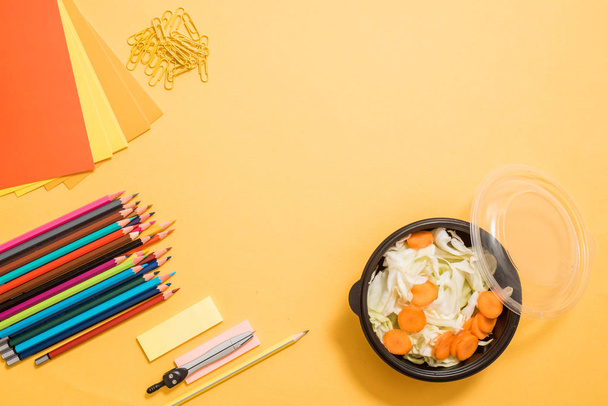 Healthy school lunch for child or teenager. Craft paper package, pile of exercise books, food in lunch box on white wood table. copy space - Valokuva, kuva