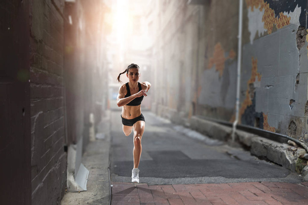 Sportswoman running race. Mixed media - Valokuva, kuva
