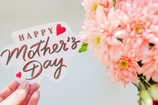 Happy Mothers day card. Greeting Card with Spring Bouquet.Pink chrysanthemum flowers.Happy Mothers Day Pastel Candy Colors Background. Floral mothers day flat lay minimal concept. Selective focus - Photo, Image