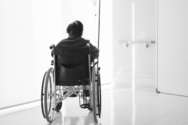 senior or elderly woman sitting on wheelchair in hospital hallway - Photo, Image
