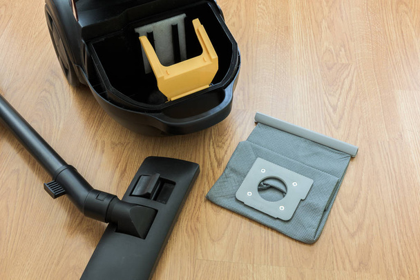 inside Vacuum cleaner and dust bag on the wooden floor - Фото, изображение