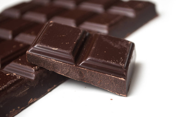 closeup of milk chocolate blocks on white background - Foto, Bild