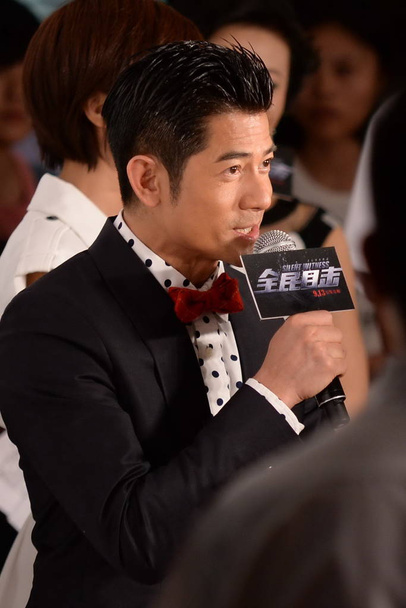Hong Kong singer and actor Aaron Kwok speaks during the premiere of his new movie, Silent Witness, in Beijing, China, 11 September 2013. - Zdjęcie, obraz