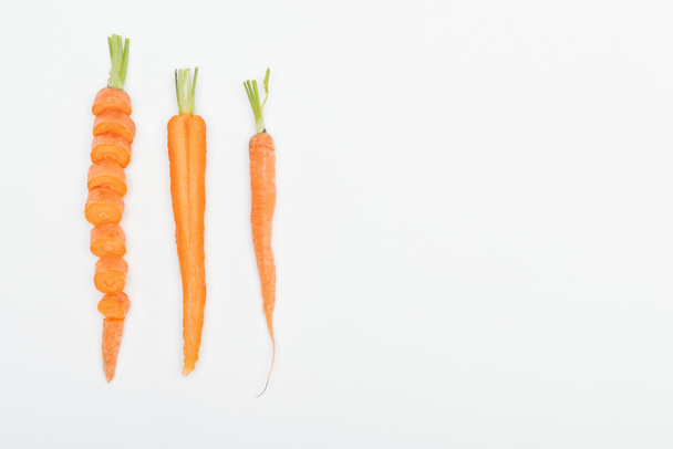 top view of sliced carrot, cut and whole carrots isolated on white with copy space - 写真・画像