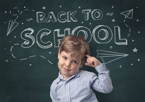 Adorable little boy with blackboard and back to school concept - Fotografie, Obrázek