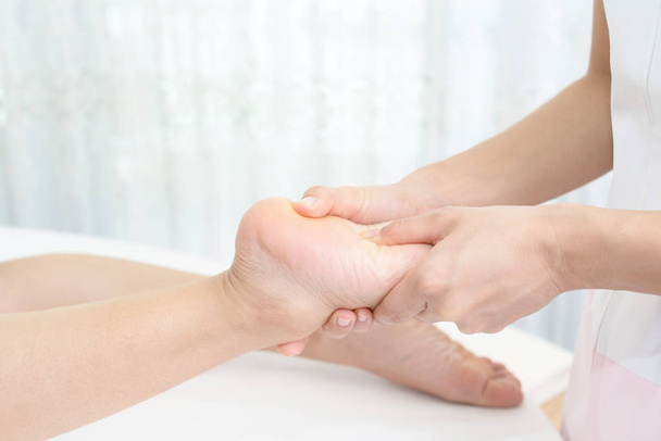 Close-up of feet receiving massage in spa - Фото, изображение