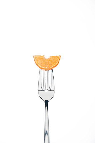 slice of fresh ripe juicy tangerine on fork isolated on white - Фото, изображение