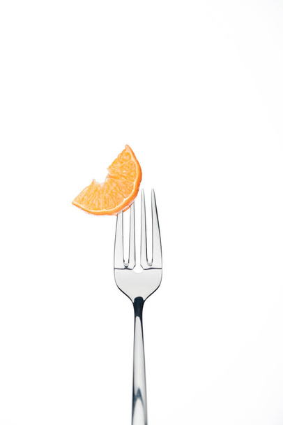 slice of fresh ripe juicy tangerine on fork isolated on white - Zdjęcie, obraz