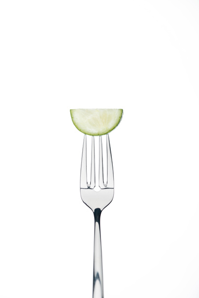 half slice of fresh ripe cucumber on fork isolated on white - Foto, afbeelding