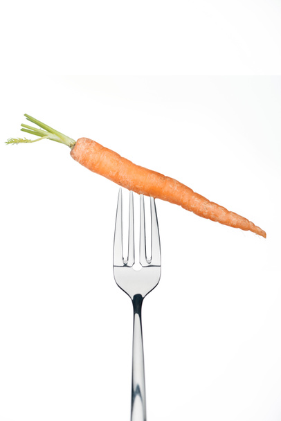 whole ripe fresh carrot on fork isolated on whiteisolated on white - Zdjęcie, obraz