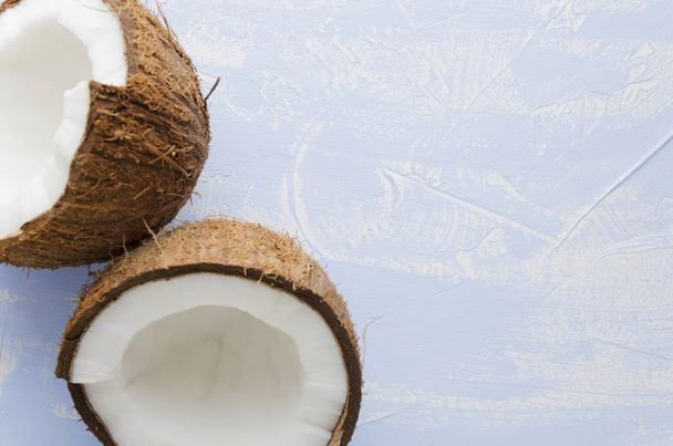 Pohled shora z kokosu halfs na modrém pozadí. Kopie prostor, closeup - Fotografie, Obrázek