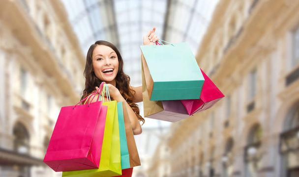 woman with shopping bags over mall background - Fotoğraf, Görsel