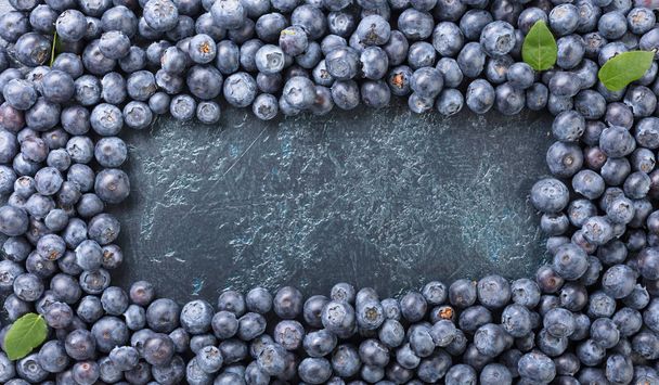  Ripe and juicy fresh picked blueberries closeup. Blueberry background.Top view . - Photo, Image