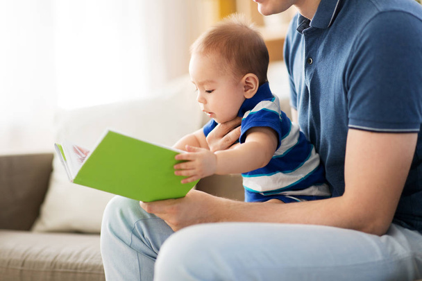 baby boy and father with book at home - Fotoğraf, Görsel