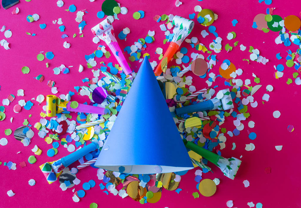 birthday celebration with paper hats, confetti, candles and party blowers - Foto, Bild