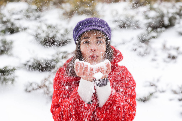 Image of a pretty young woman outdoors walking in snow winter park forest. - 写真・画像