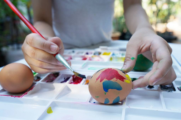 Colorful easter eggs painting activity with color tray background, fun event for kid concept, copy space - Photo, Image