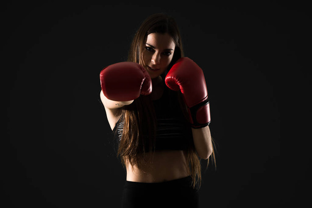 Young sport woman with boxing gloves - Foto, afbeelding