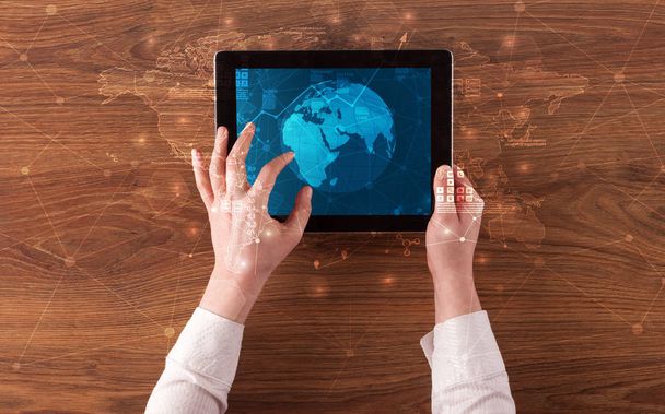 Hand holding tablet with global reports and stock market change concept - Foto, Bild