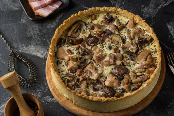 Mushroom Quiche Pie with champignons and cheese on dark background, top view. Savory tart with mushrooms. Galette. Tart with chicken. Chicken pie. Mushroom pie - Fotó, kép