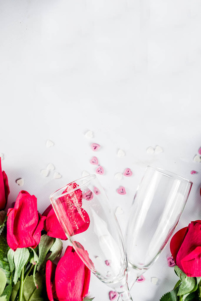 Valentine day concept, Red roses with two champagne glasses, copy space top view - Фото, изображение