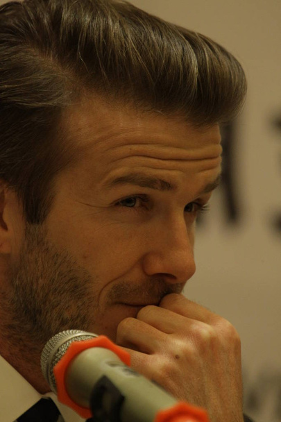 English soccer superstar David Beckham reacts during a press conference in Qingdao city, east Chinas Shandong province, 22 March 2013 - Photo, Image