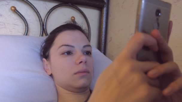 Woman is browsing internet in mobole phone, Face close-up. - Πλάνα, βίντεο