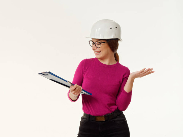emotional girl foreman in a helmet on a white background 5 - Fotó, kép
