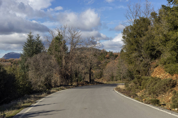 A narrow, rural road in the mountains in the winter sunny day (Greece, Peloponnese, mountain range Taygetus). - Zdjęcie, obraz